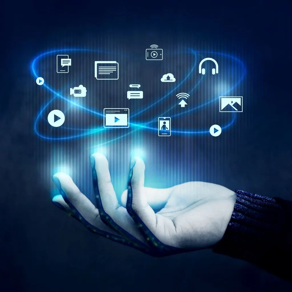 Open hand holding glowing digital media icons above it on a dark blue background