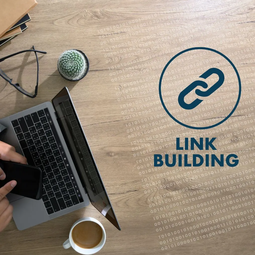 Laptop and coffee on a wooden desk next to a link building chain icon